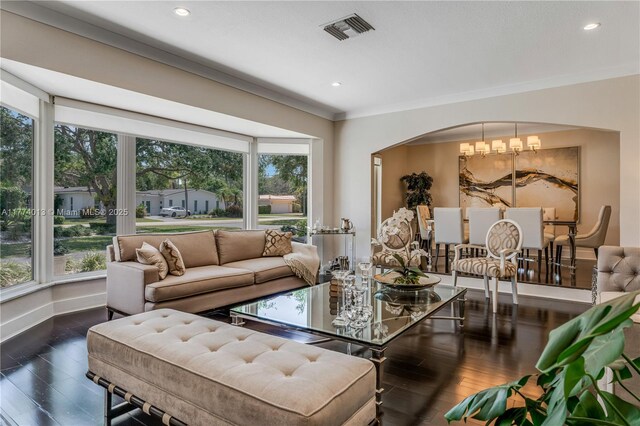 7465 SW 159th Ter, Palmetto Bay, FL 33157 - living area with a chandelier, wood finished floors, visible vents, arched walkways, and ornamental molding