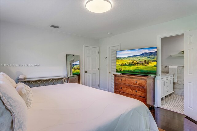 7465 SW 159th Ter, Palmetto Bay, FL 33157 - bedroom with dark wood finished floors, ensuite bathroom, and visible vents