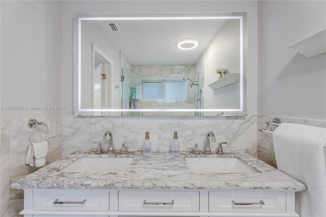 7465 SW 159th Ter, Palmetto Bay, FL 33157 - full bathroom with visible vents, a sink, double vanity, and a shower stall