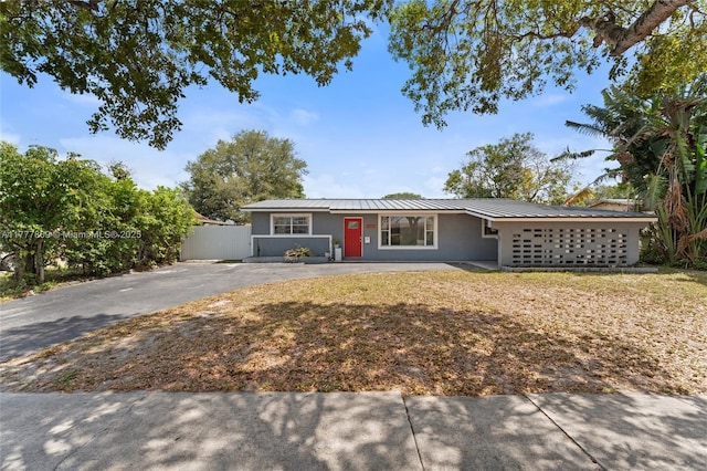 6930 SW 5th St, Pembroke Pines, FL 33023 - ranch-style house with metal roof, fence, stucco siding, and driveway