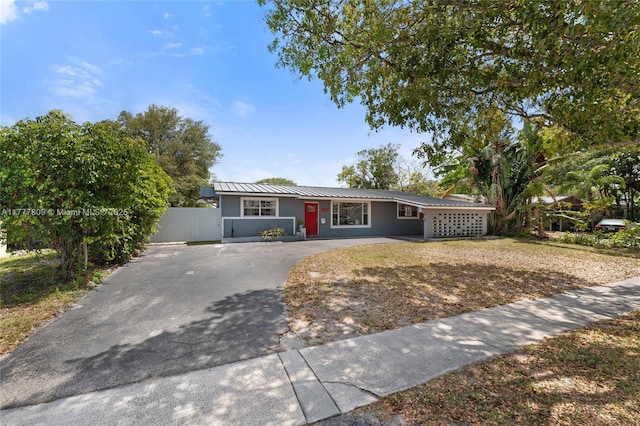 6930 SW 5th St, Pembroke Pines, FL 33023 - ranch-style home featuring asphalt driveway and a metal roof
