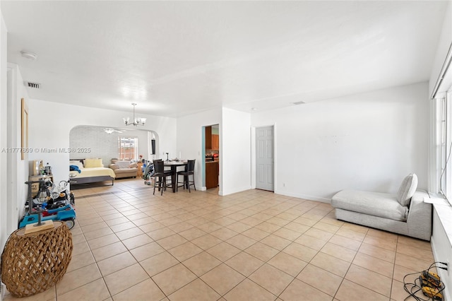 6930 SW 5th St, Pembroke Pines, FL 33023 - living room with arched walkways, light tile patterned flooring, and a chandelier