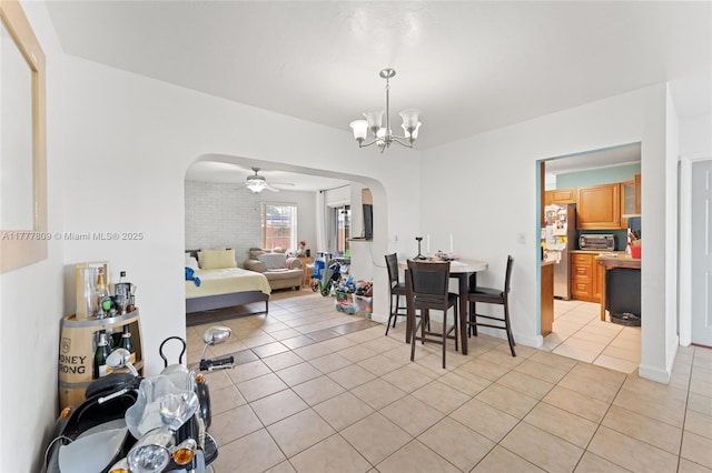 6930 SW 5th St, Pembroke Pines, FL 33023 - dining area featuring arched walkways, light tile patterned floors, a toaster, and ceiling fan with notable chandelier