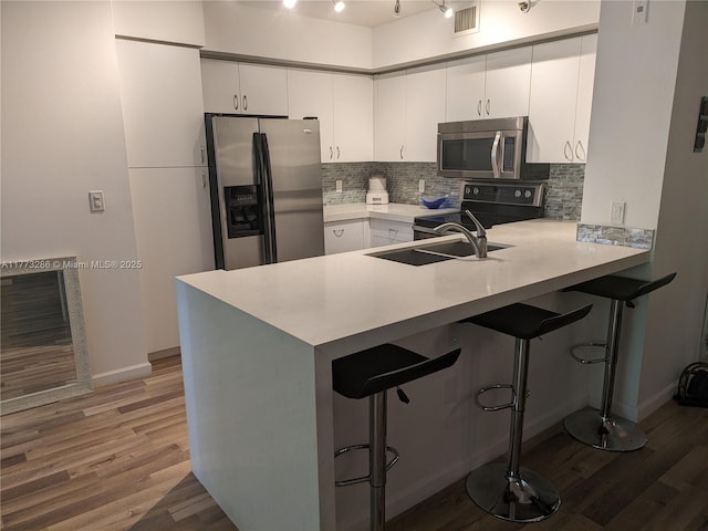 19901 E Country Club Dr Unit 2305, Aventura, FL 33180 - kitchen featuring light countertops, tasteful backsplash, stainless steel appliances, a sink, and a peninsula