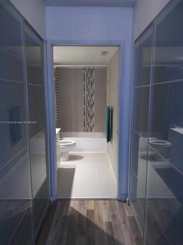 19901 E Country Club Dr Unit 2305, Aventura, FL 33180 - bathroom with visible vents, walk in shower, toilet, wood finished floors, and vanity
