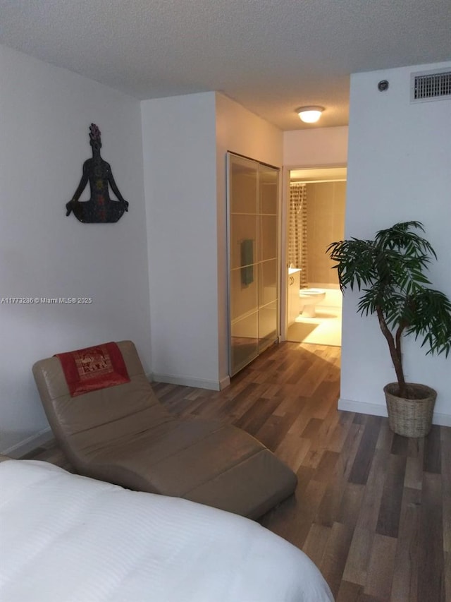 19901 E Country Club Dr Unit 2305, Aventura, FL 33180 - bedroom featuring baseboards, visible vents, a textured ceiling, and wood finished floors