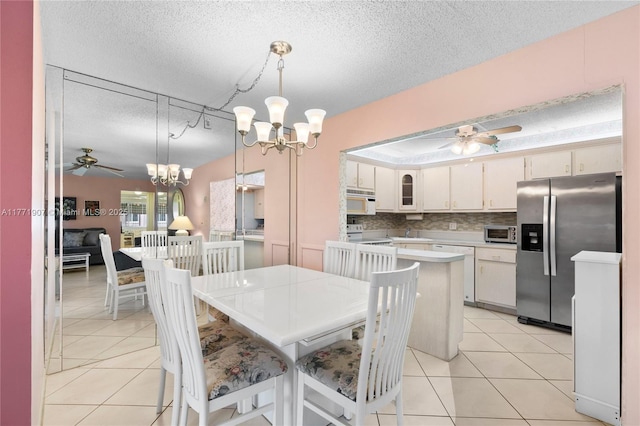 336 Pine Ridge Cir Unit B-1, Green Acres, FL 33463 - dining area featuring light tile patterned floors, a textured ceiling, and ceiling fan with notable chandelier