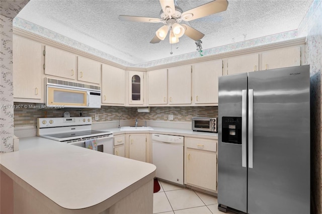 336 Pine Ridge Cir Unit B-1, Green Acres, FL 33463 - kitchen with light countertops, white appliances, a peninsula, and a textured ceiling