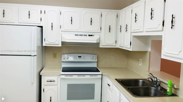 kitchen with a sink, light countertops, white appliances, under cabinet range hood, and white cabinetry