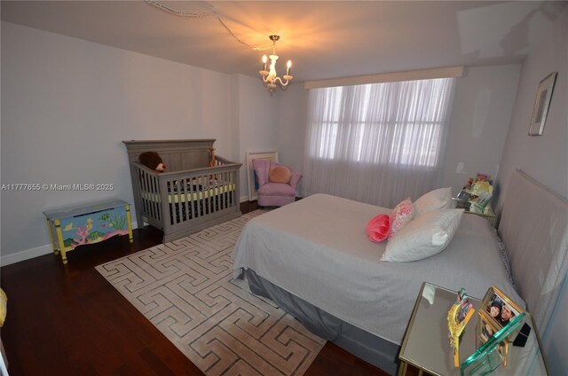 1800 NE 114th St Unit 1903, Miami, FL 33181 - bedroom with baseboards, wood finished floors, and a chandelier