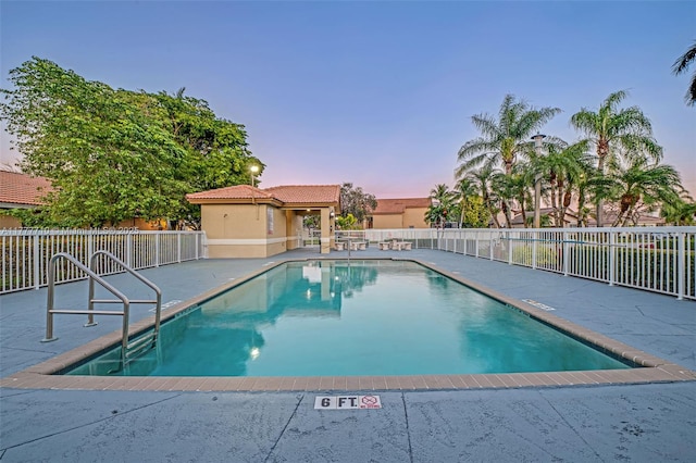 17663 SW 5th St, Pembroke Pines, FL 33029 - pool at dusk with a community pool, a patio area, and fence