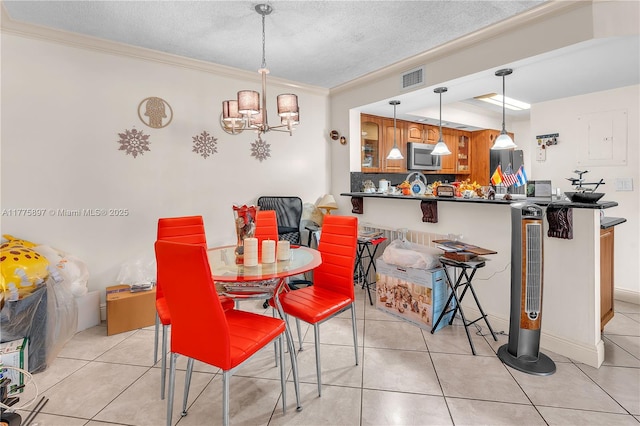 18840 NW 57th Ave Unit 107, Hialeah, FL 33015 - dining area featuring light tile patterned flooring, a textured ceiling, visible vents, a chandelier, and ornamental molding