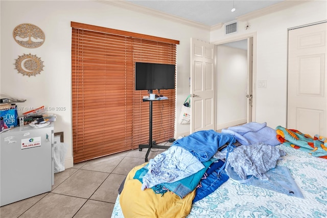 18840 NW 57th Ave Unit 107, Hialeah, FL 33015 - bedroom featuring refrigerator, light tile patterned floors, baseboards, visible vents, and ornamental molding