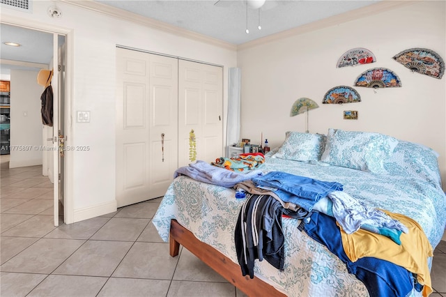 18840 NW 57th Ave Unit 107, Hialeah, FL 33015 - bedroom featuring a closet, visible vents, baseboards, ornamental molding, and light tile patterned floors