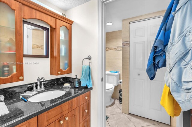 18840 NW 57th Ave Unit 107, Hialeah, FL 33015 - bathroom with tile patterned floors, toilet, vanity, and a textured ceiling