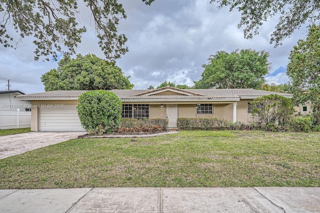 single story home featuring stucco siding, driveway, an attached garage, a front yard, and a tile roof