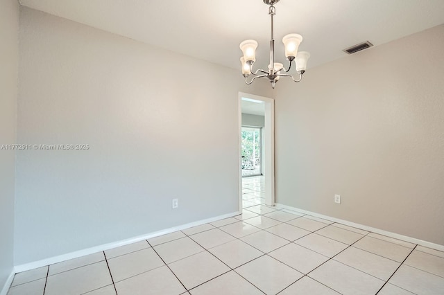 spare room featuring visible vents, baseboards, an inviting chandelier, and light tile patterned floors