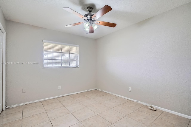spare room featuring baseboards and ceiling fan