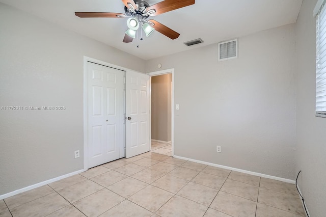 unfurnished bedroom featuring visible vents, baseboards, and a closet