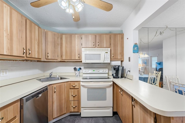 337 Pine Ridge Cir Unit C-1, Green Acres, FL 33463 - kitchen featuring ceiling fan, white appliances, a peninsula, a textured ceiling, and a sink