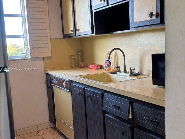 1701 Washington St Unit 404, Hollywood, FL 33020 - kitchen featuring a sink, light countertops, freestanding refrigerator, light tile patterned floors, and dishwasher