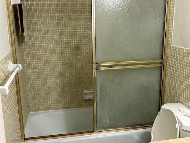 1701 Washington St Unit 404, Hollywood, FL 33020 - full bathroom featuring toilet, tile walls, and enclosed tub / shower combo