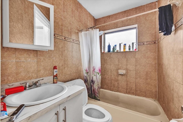 bathroom with vanity, tile walls, and shower / tub combo with curtain