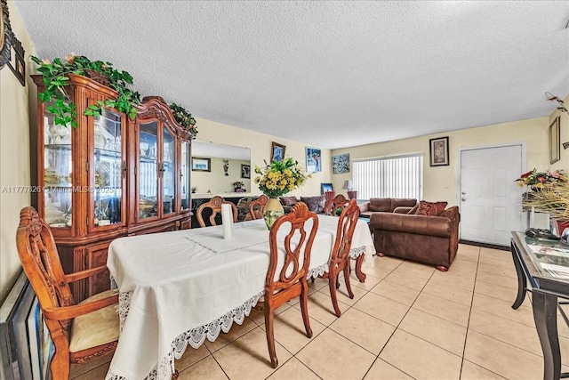 dining room featuring light tile patterned floors and a textured ceiling