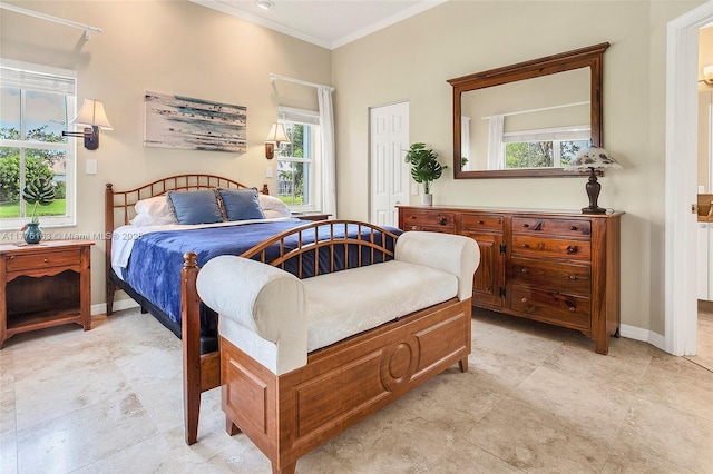 bedroom featuring baseboards, multiple windows, crown molding, and a closet