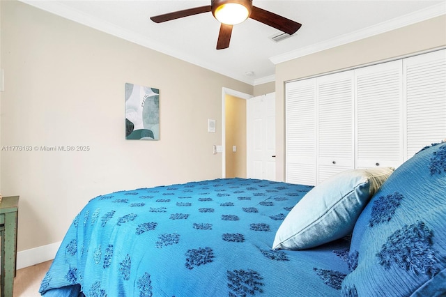 carpeted bedroom featuring crown molding, a closet, ceiling fan, and baseboards