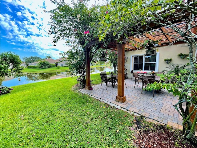 view of yard with a water view, a patio area, and a pergola