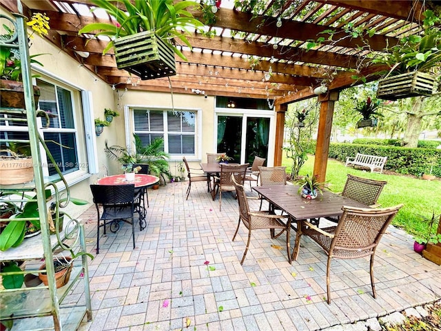 view of patio with outdoor dining space and a pergola