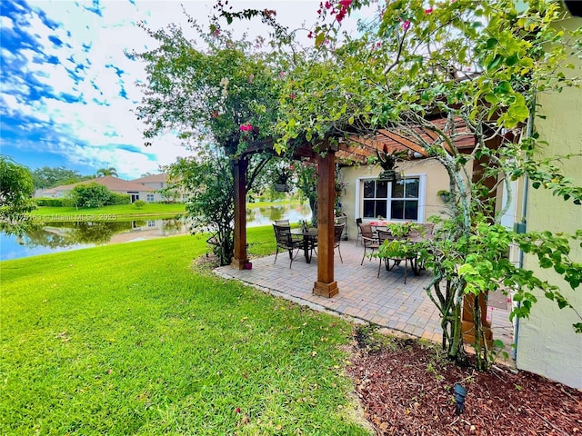 view of yard with a water view, a patio area, and a pergola