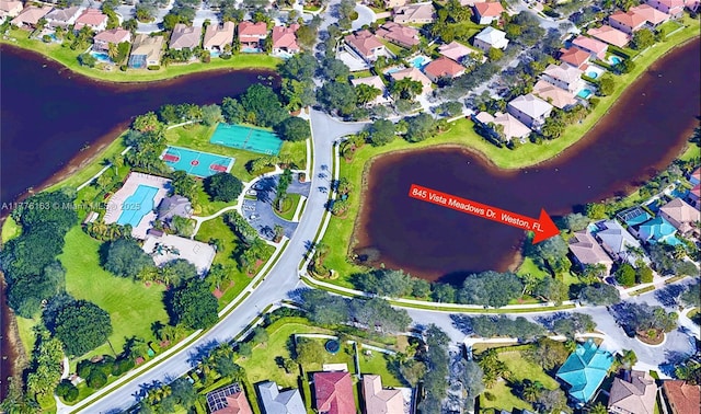 bird's eye view featuring a water view and a residential view