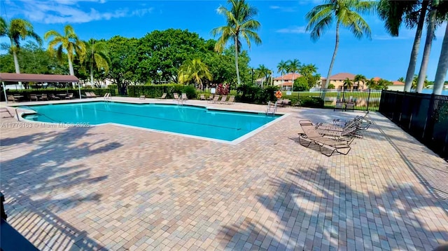 pool with fence and a patio