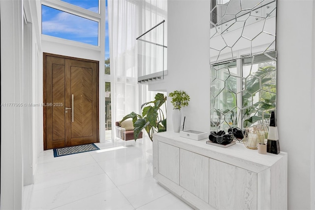 foyer with tile patterned floors and a high ceiling