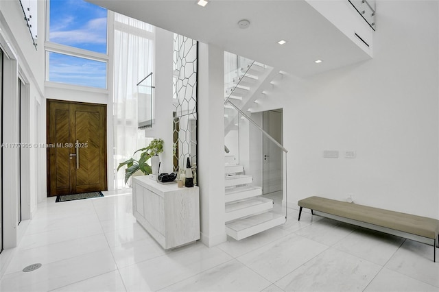 stairway featuring a high ceiling