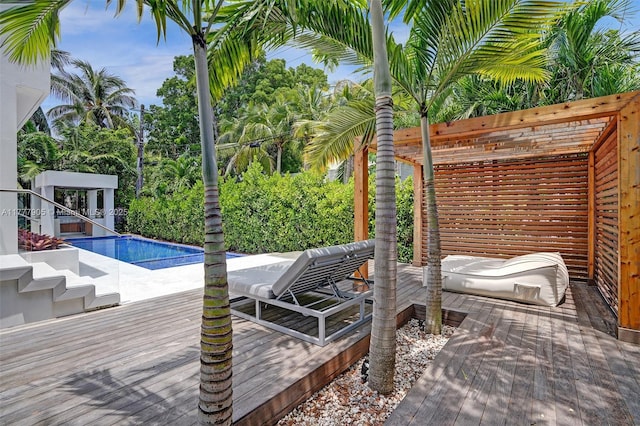 outdoor pool with a wooden deck and stairway