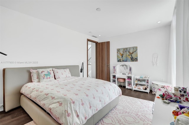 bedroom with recessed lighting and wood finished floors