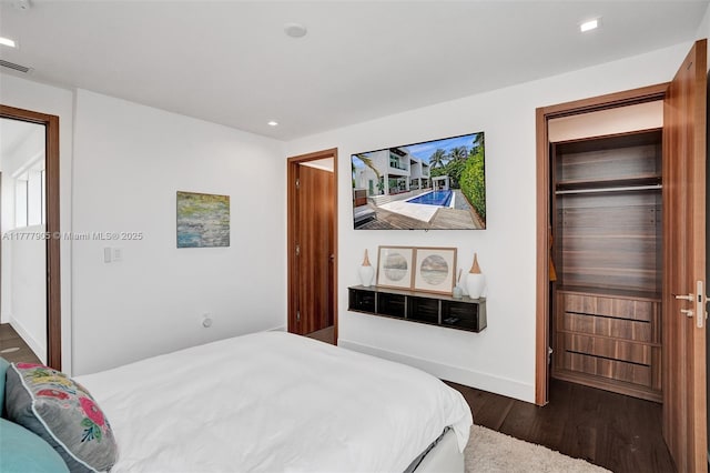 bedroom featuring recessed lighting, baseboards, and dark wood-style floors