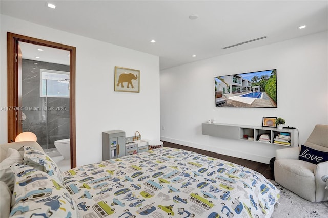 bedroom with ensuite bath, recessed lighting, baseboards, wood finished floors, and visible vents