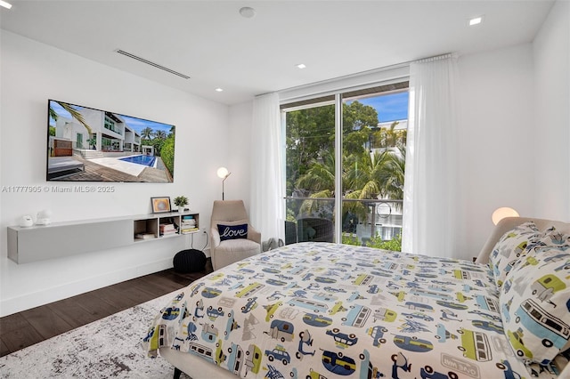 bedroom with recessed lighting and wood finished floors