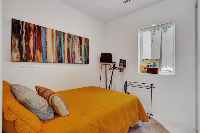 tiled bedroom featuring baseboards