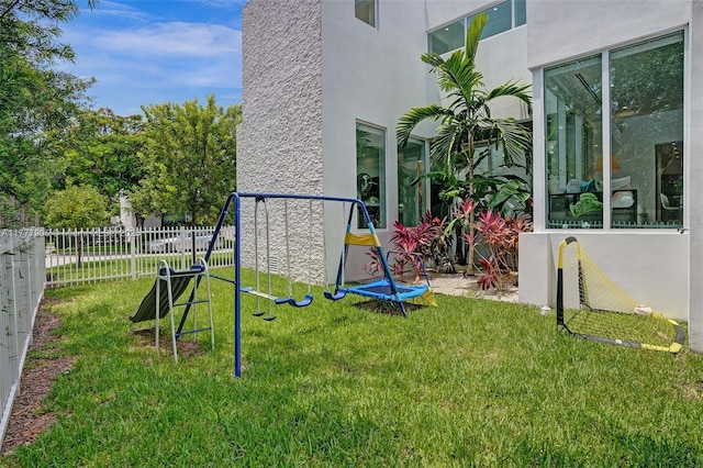 view of yard with fence and a playground
