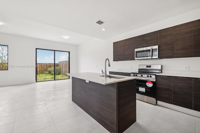 18918 SW 345th Ter, Homestead, FL 33034 - kitchen with stainless steel appliances, a sink, light countertops, modern cabinets, and dark brown cabinetry