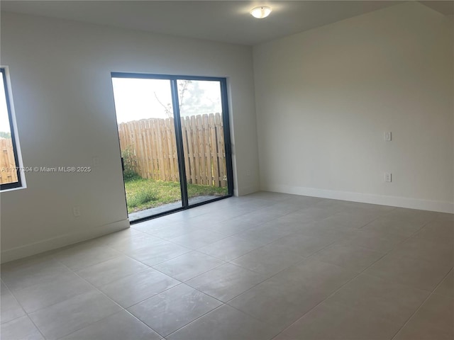 spare room featuring baseboards