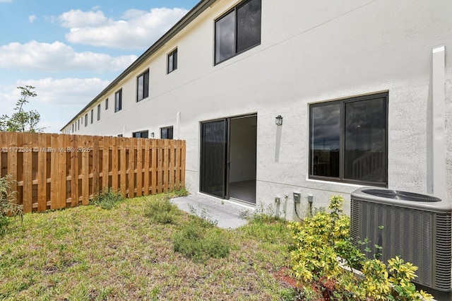 18918 SW 345th Ter, Homestead, FL 33034 - rear view of property with central AC and stucco siding