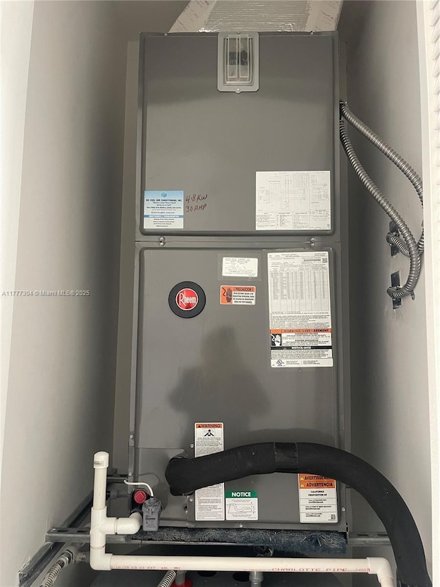 utility room featuring heating unit