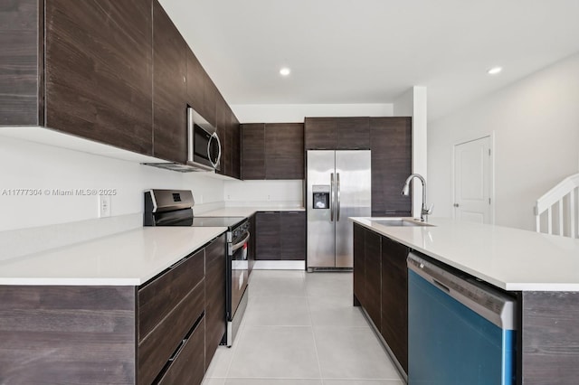 18918 SW 345th Ter, Homestead, FL 33034 - kitchen with stainless steel appliances, a sink, modern cabinets, light countertops, and dark brown cabinets