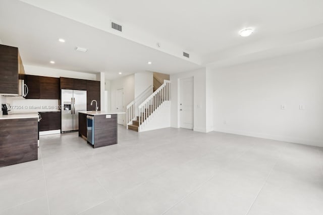 18918 SW 345th Ter, Homestead, FL 33034 - kitchen featuring stainless steel appliances, light countertops, modern cabinets, dark brown cabinetry, and an island with sink